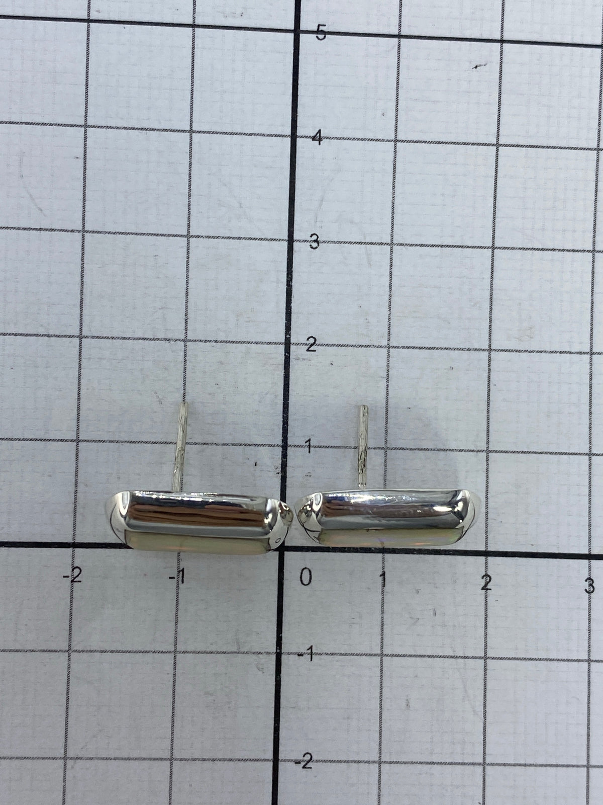 Aretes sobre fondo blanco con marca del Quinto 925 visible