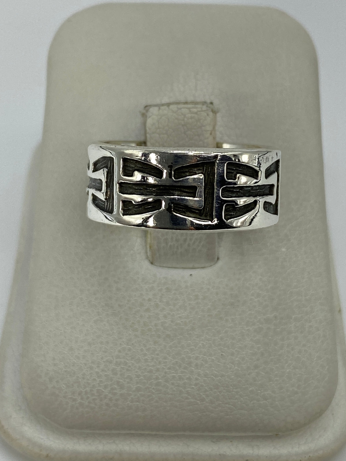 Anillo de plata 925 con repujado geométrico prehispánico en la mano de una mujer