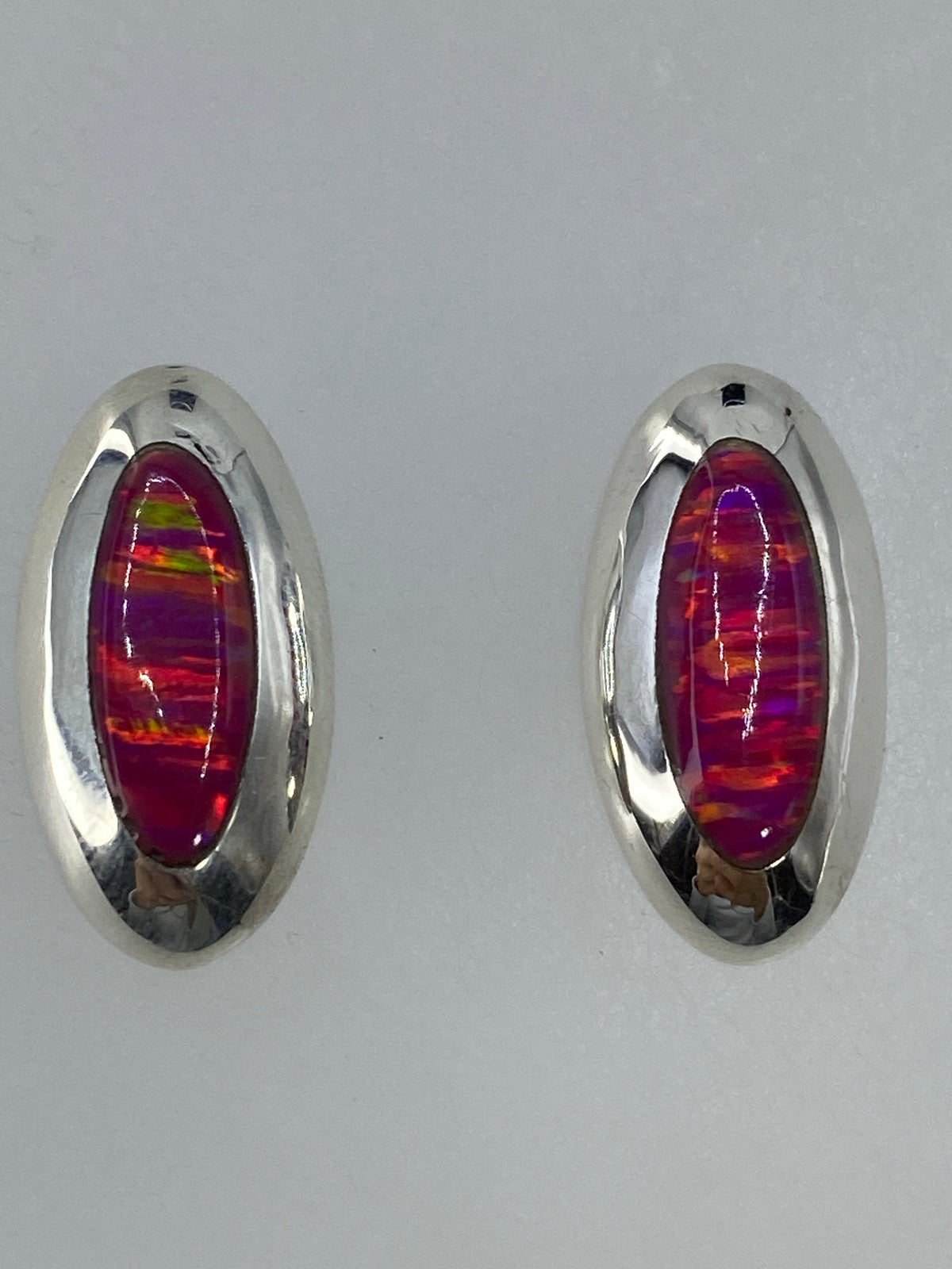 Aretes con ópalo rosa en escala de centímetros, vista lateral