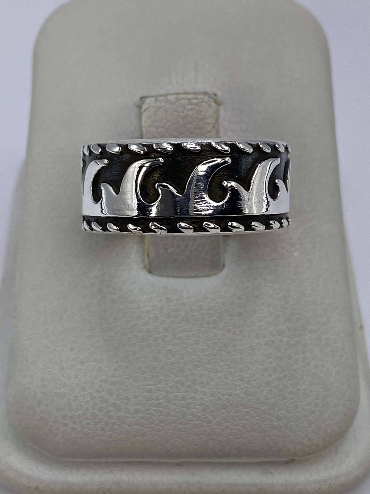 Anillo de plata repujado con ondas étnicas en relieve, en mano femenina