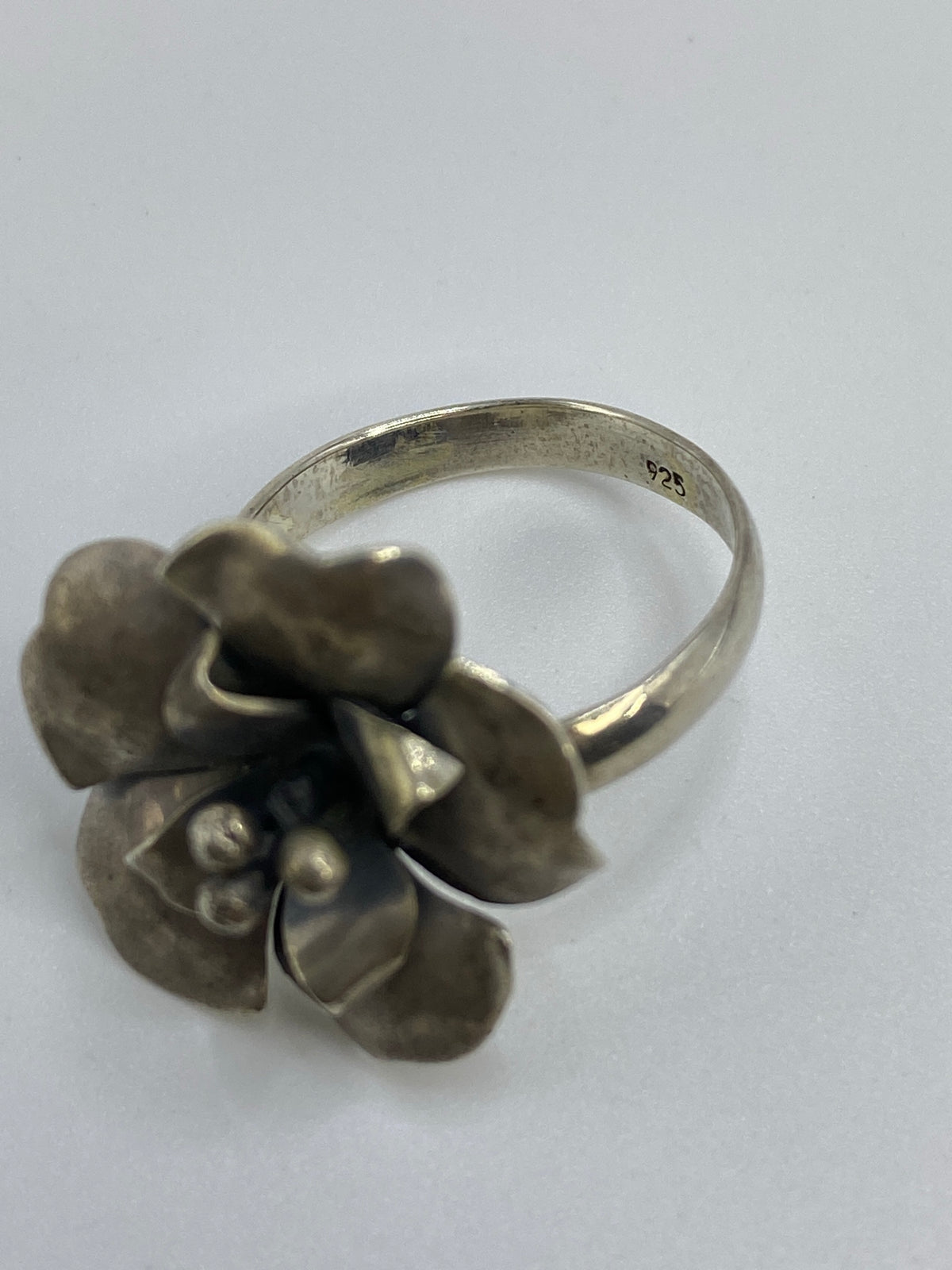 Anillo de plata flor en talla 8.5 sobre fondo blanco con Quinto 925 visible