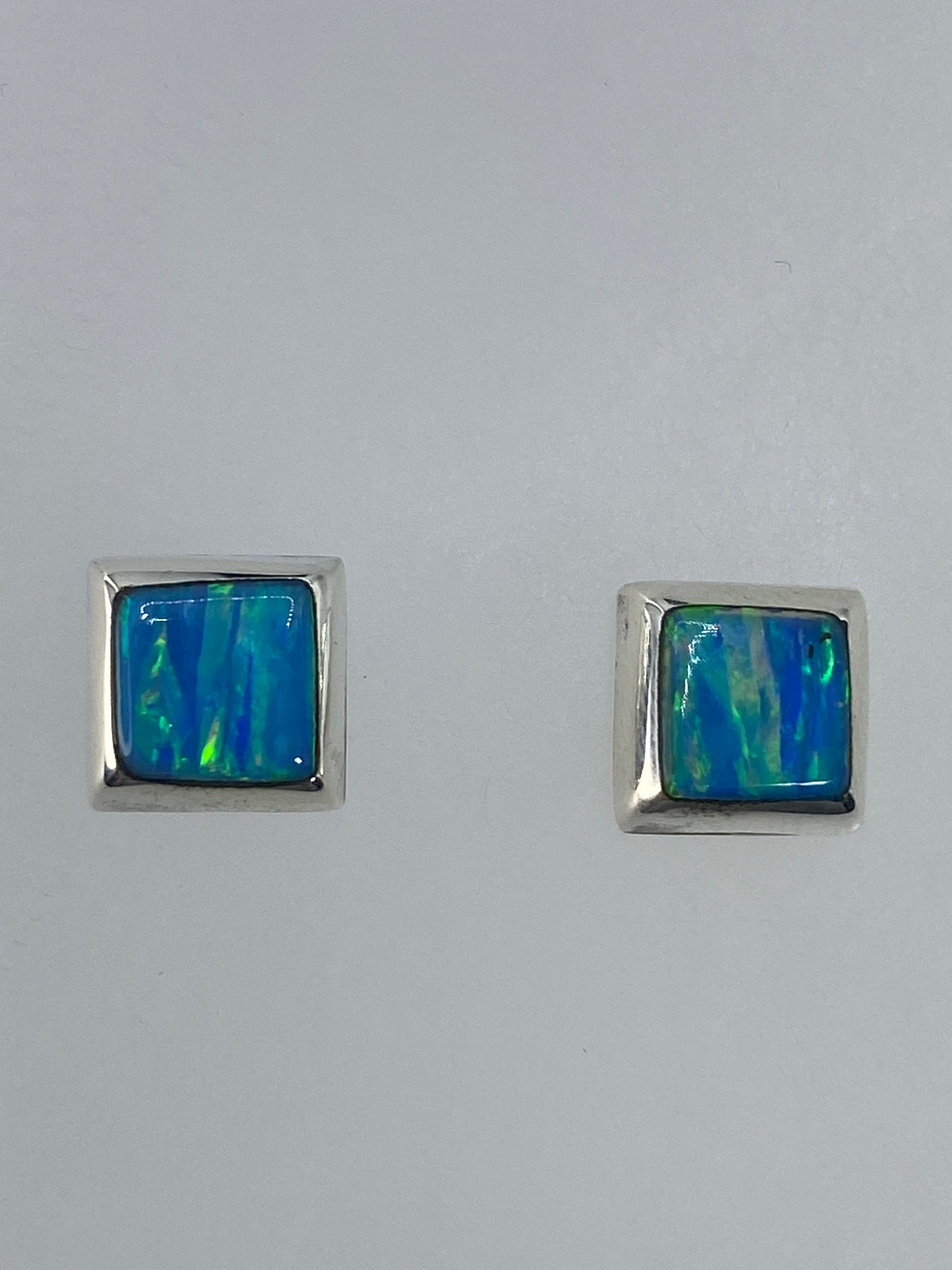 Detalle de un arete mostrando el opalo de fuego y el Quinto 925