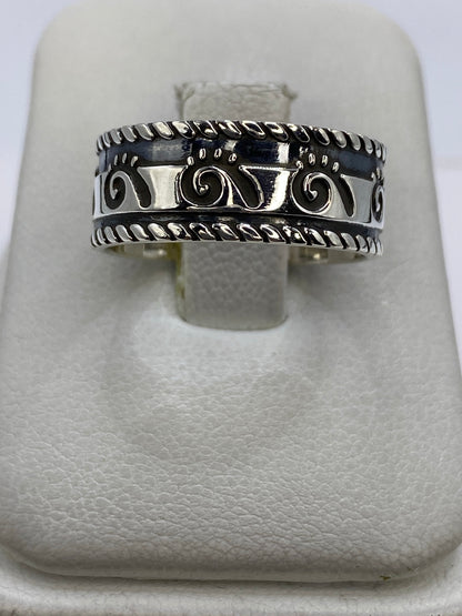 Anillo de plata 925 repujado con motivos geométricos étnicos en la mano de un hombre