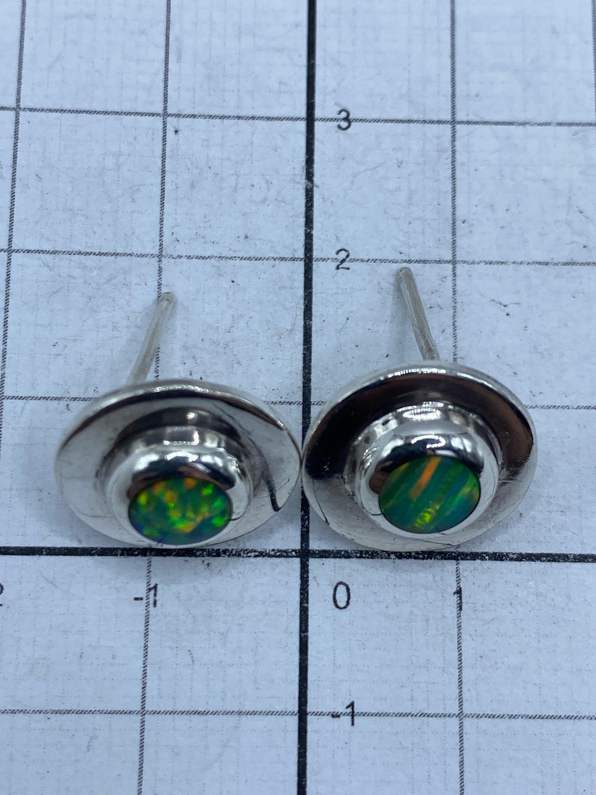 Aretes en la oreja, mostrando el tamaño real y el brillo del ópalo