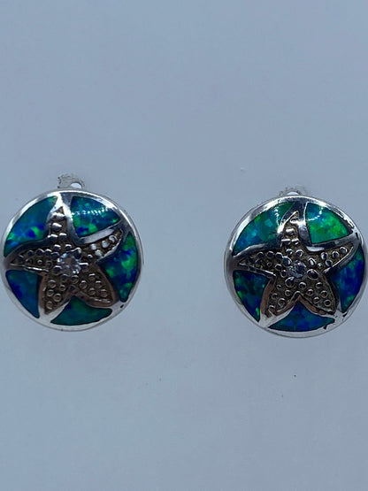 Aretes de ópalo de fuego azul vistos de frente mostrando el Quinto