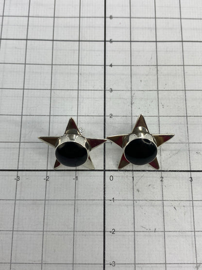 Aretes en la mano mostrando el tamaño real de 2.3 cm de largo