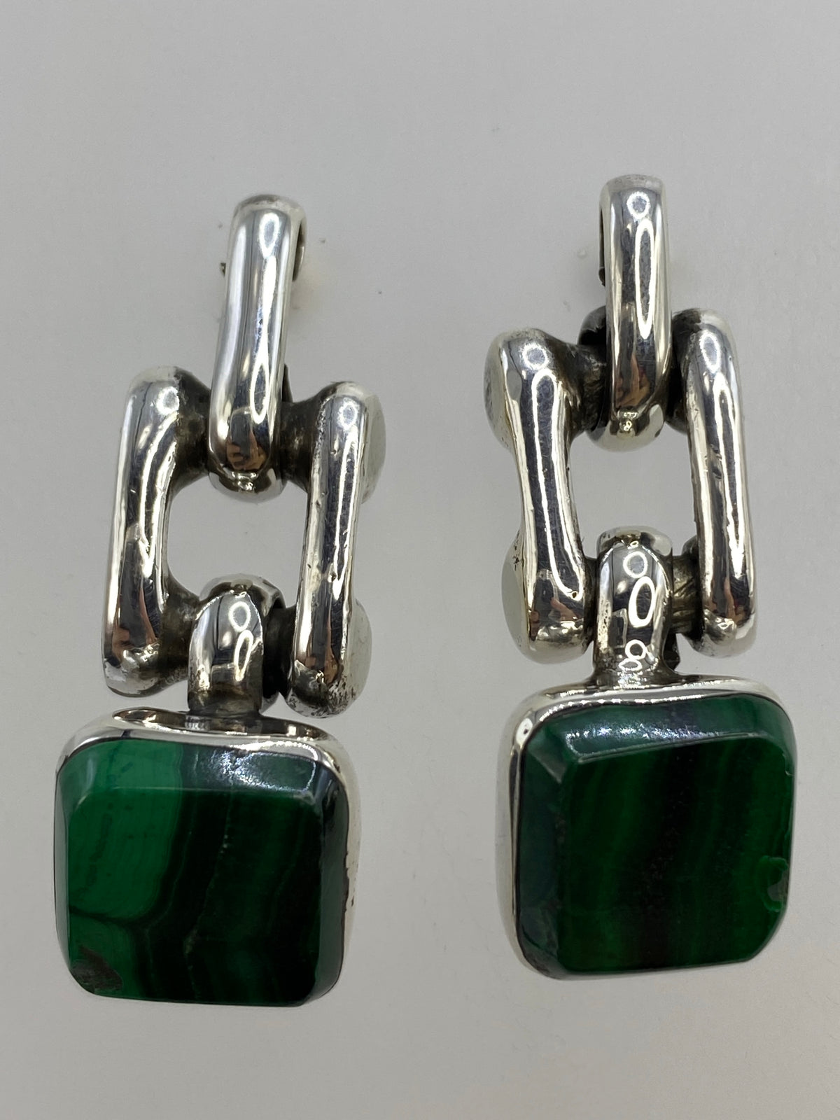 Aretes sobre regla de medición mostrando largo 3.6 cm y ancho 1.6 cm