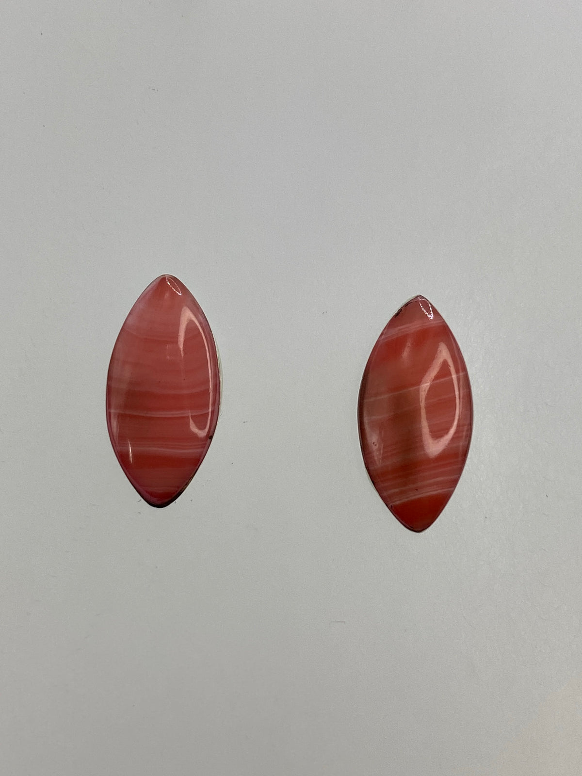 Par de aretes minimalistas de plata con coral rosa natural engastado, vista frontal