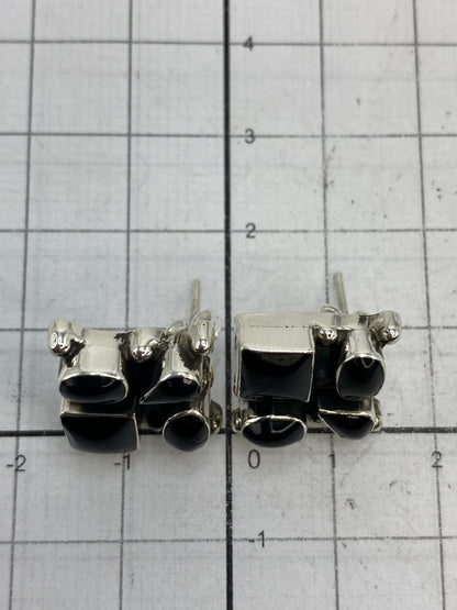 Escala de medida: aretes de 1.5 × 1.4 cm comparados con rejilla