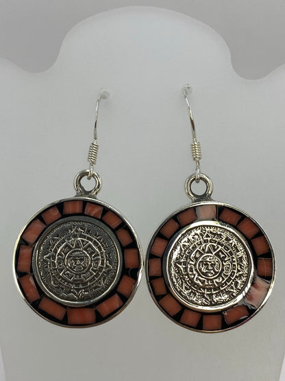Vista lateral de los aretes mostrando el peso y la profundidad del diseño prehispánico
