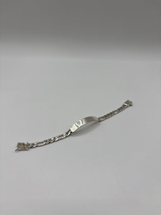 Detalle de cierre de broche de seguridad en pulsera eslabón figaro de plata pura