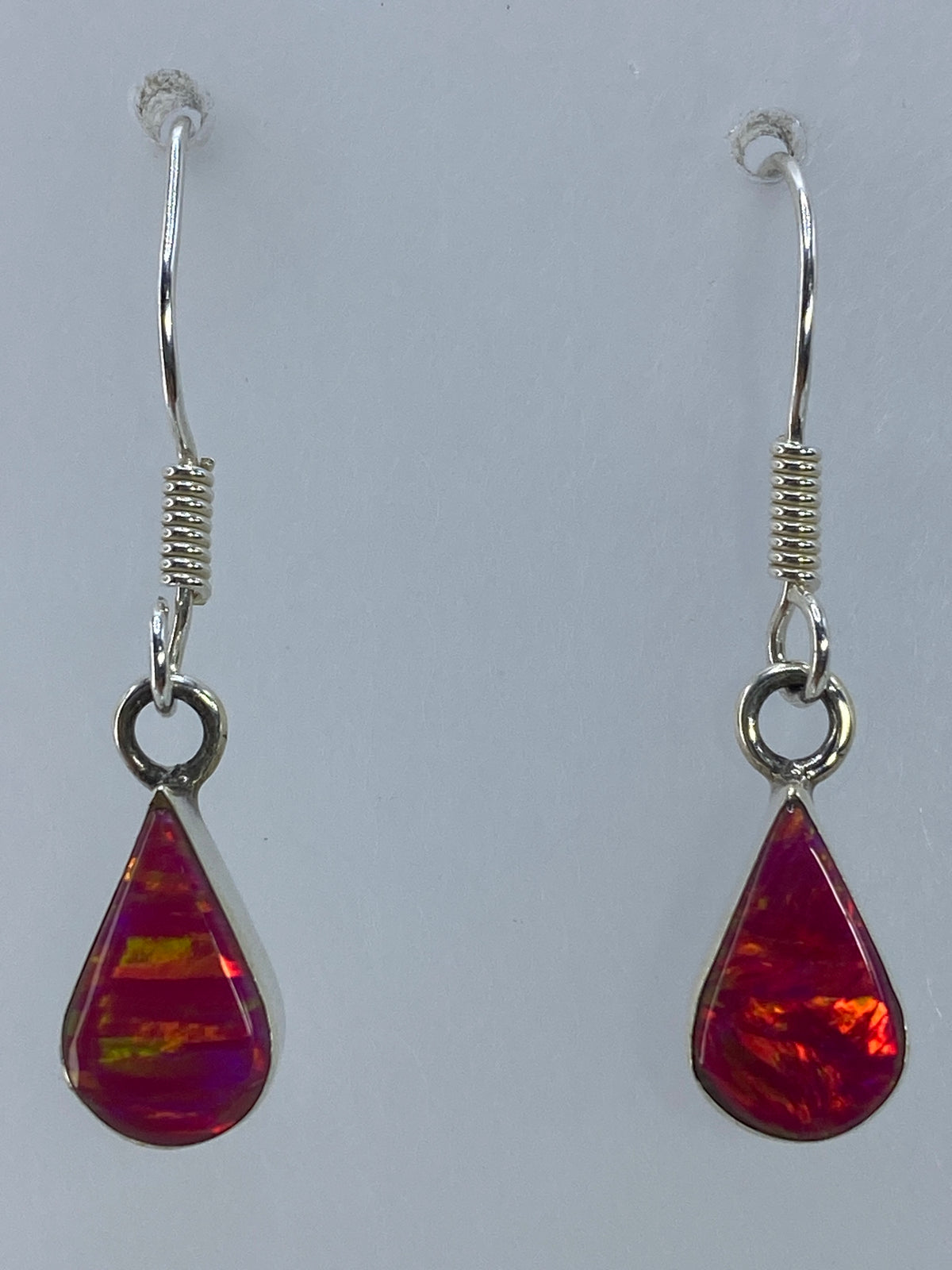 Aretes de ópalo de fuego rosa con gancho francés de plata, vista lateral