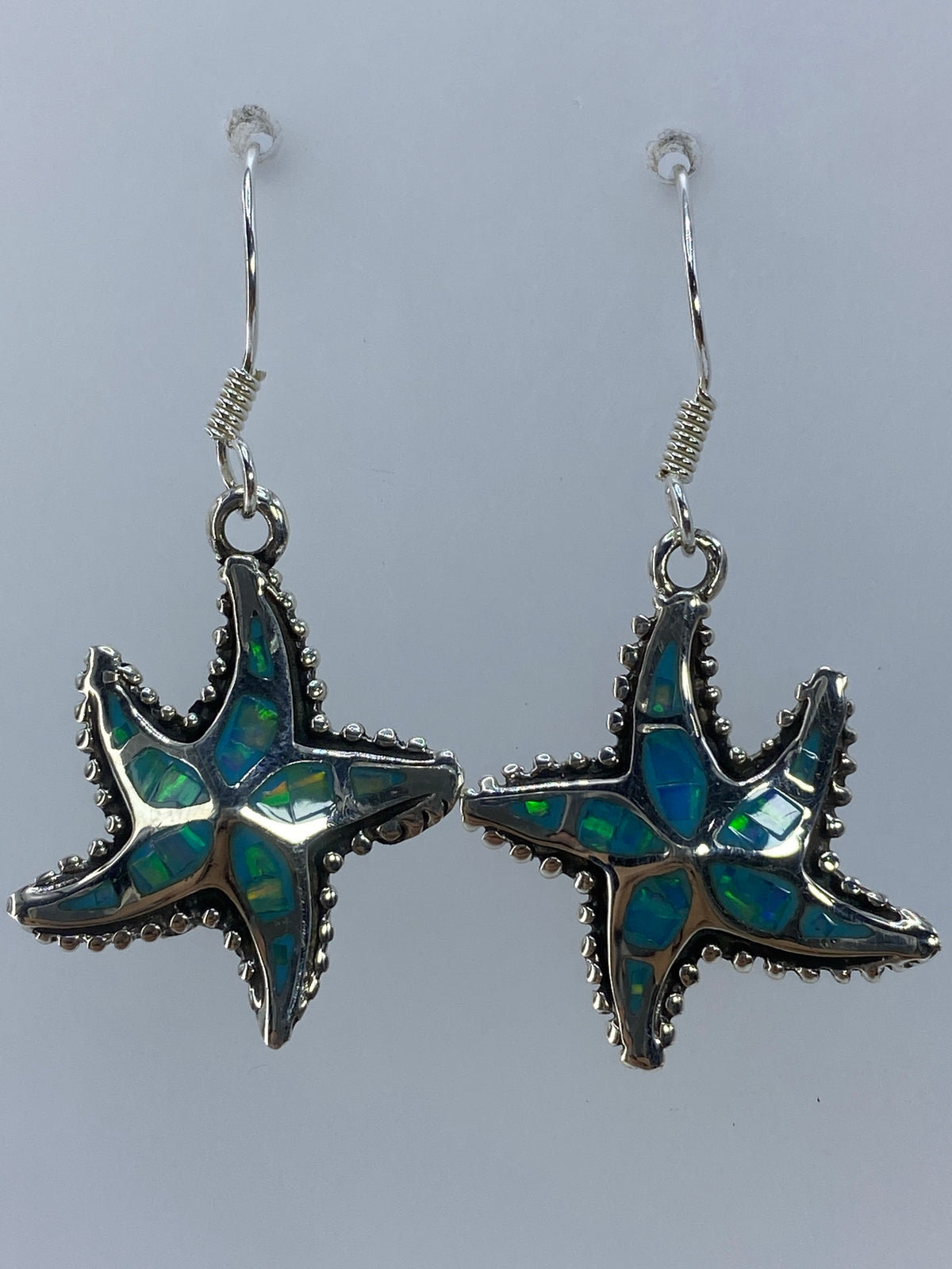 Par de aretes de plata en forma de estrella marina con ópalo de fuego verde limón