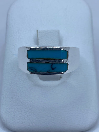 Anillo de plata con turquesa azul engastada en diseño geométrico, visto desde arriba