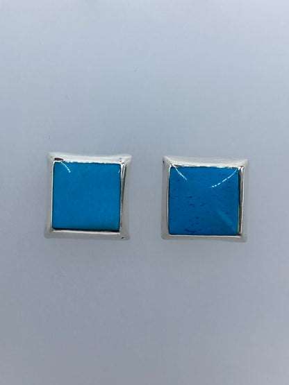 Aretes de plata con turquesa azul engastada, vista frontal del par
