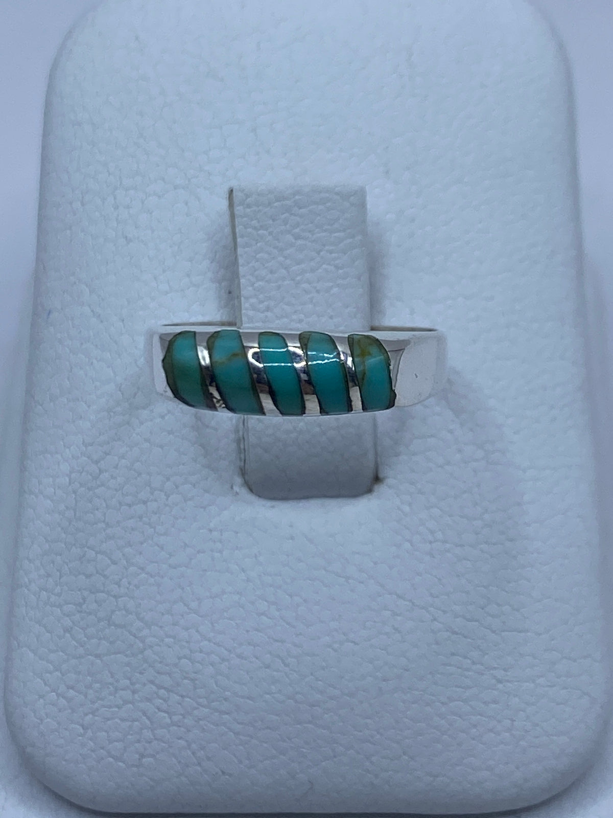 Anillo de plata con turquesa azul cielo engastada, visto sobre fondo blanco