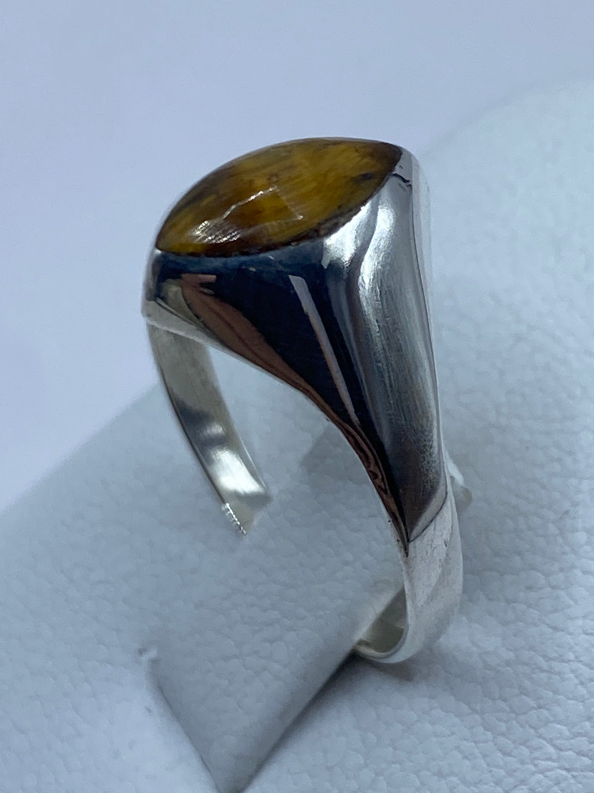 Anillo puesto en la mano, Ojo de Tigre brillando con su efecto de luz caracteristico