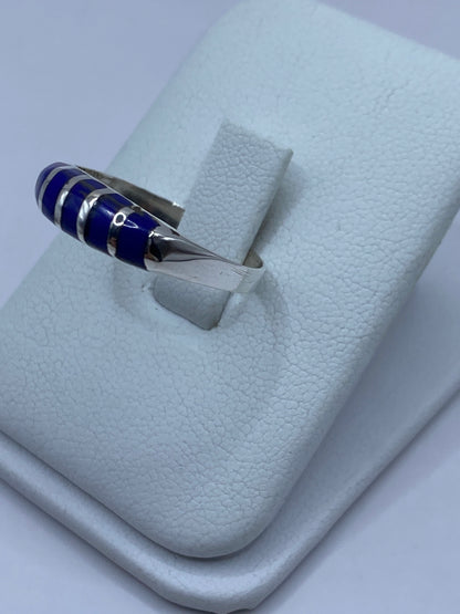 Detalle lateral del anillo mostrando el engaste a mano de la piedra azul