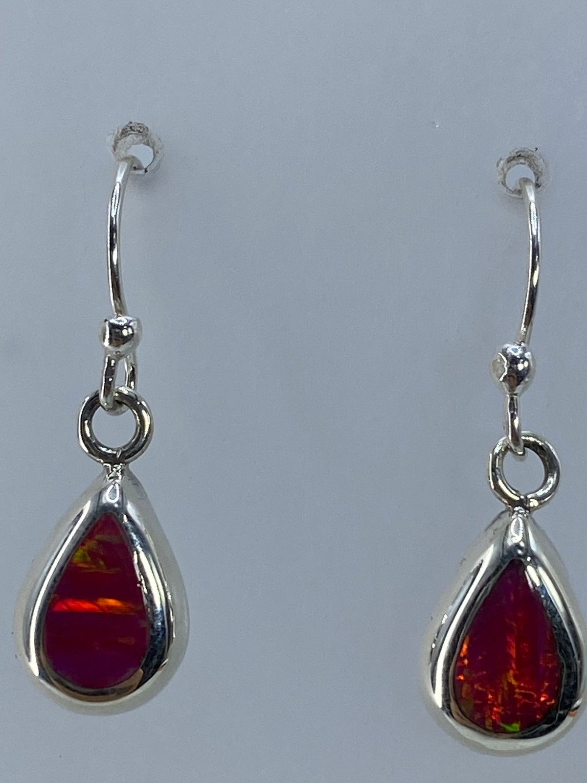 Aretes sobre regla de medición mostrando los 2.5 cm de largo
