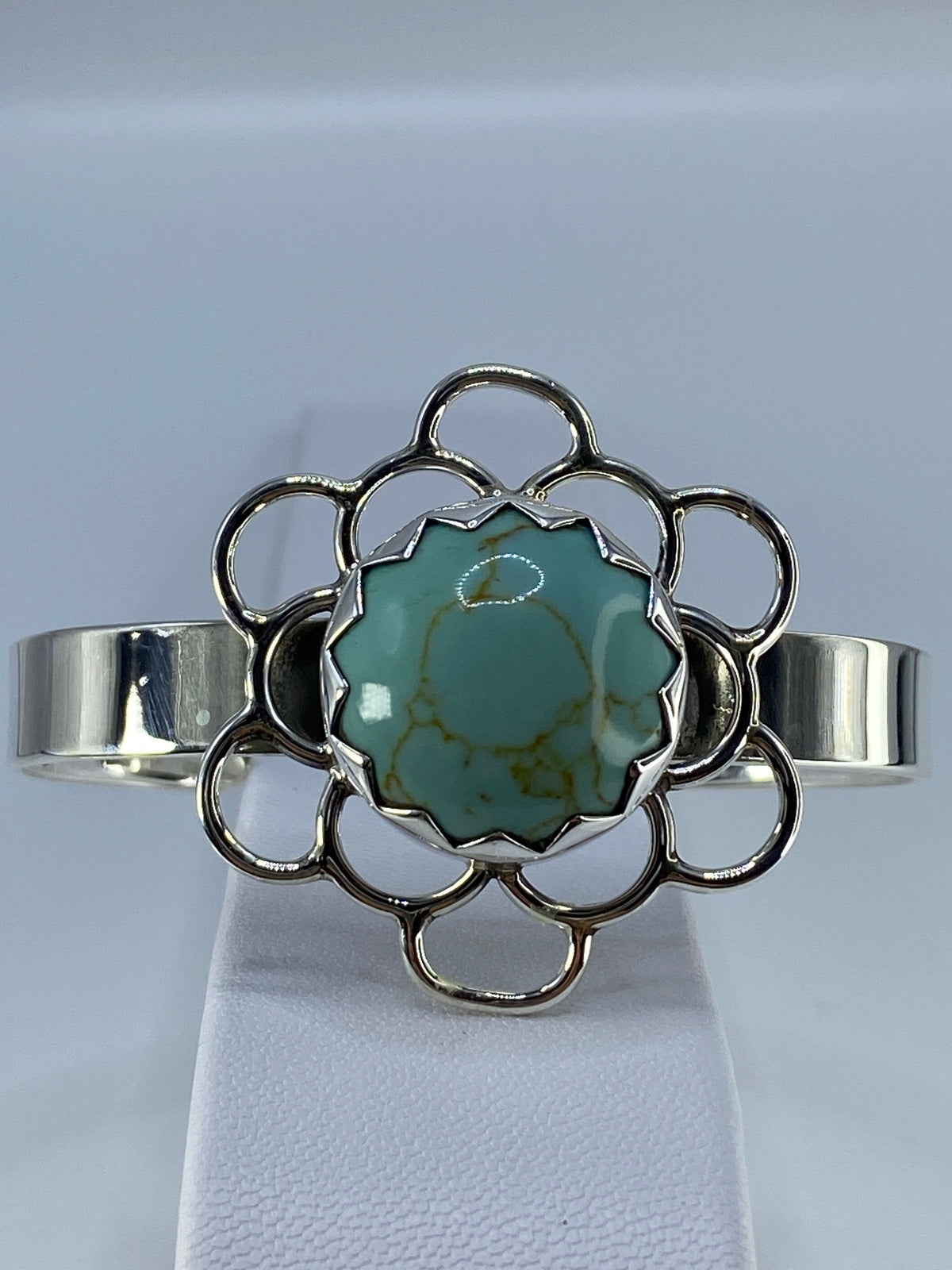 Detalle del diseño floral en anillo y la turquesa azul natural