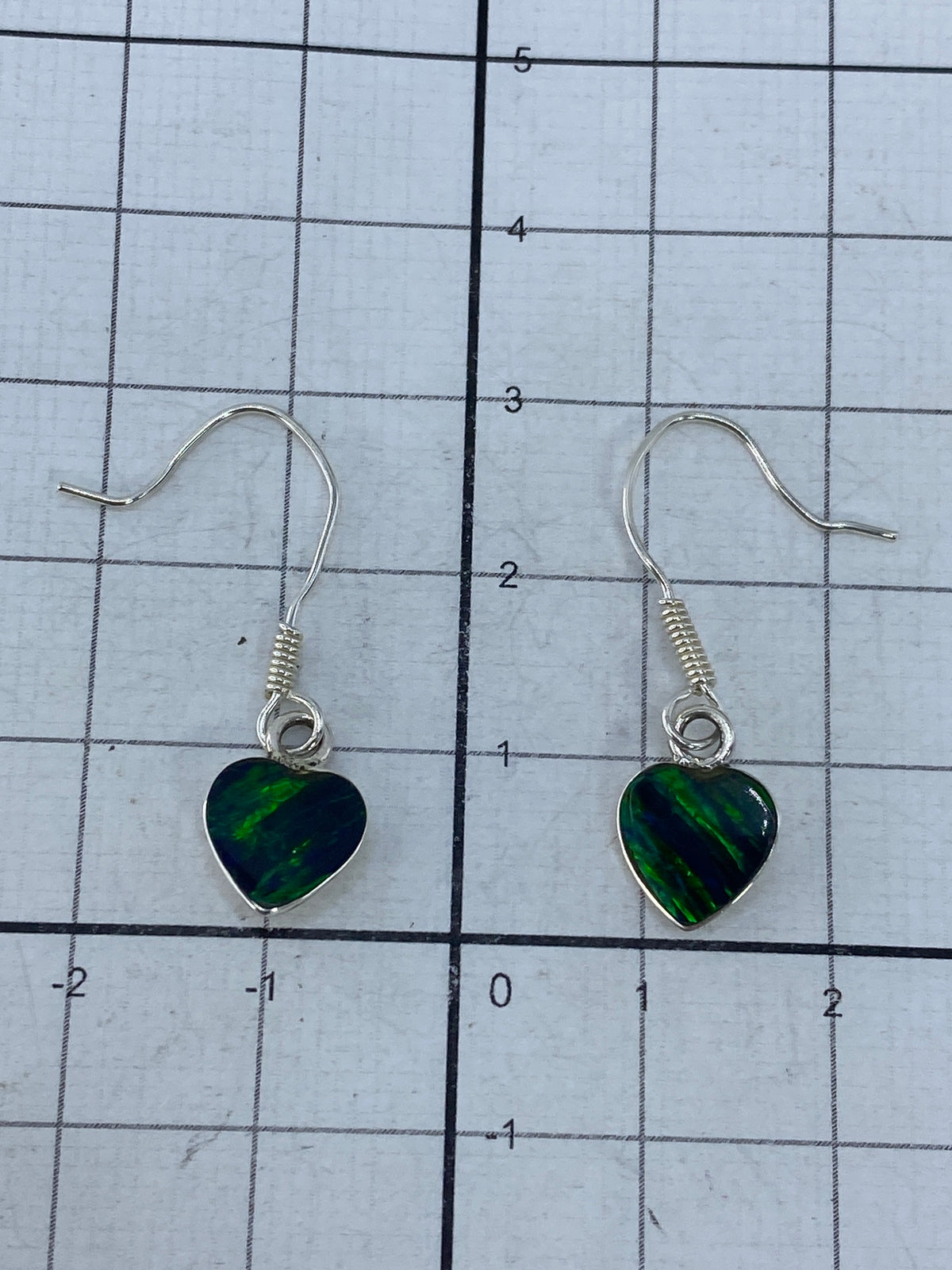 Aretes de plata sobre fondo blanco, medida real de 3 cm de largo