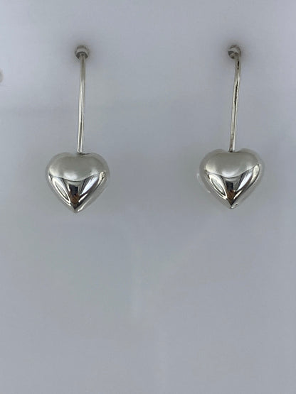 Detalle lateral de un arete de corazón en plata 925, visto de perfil