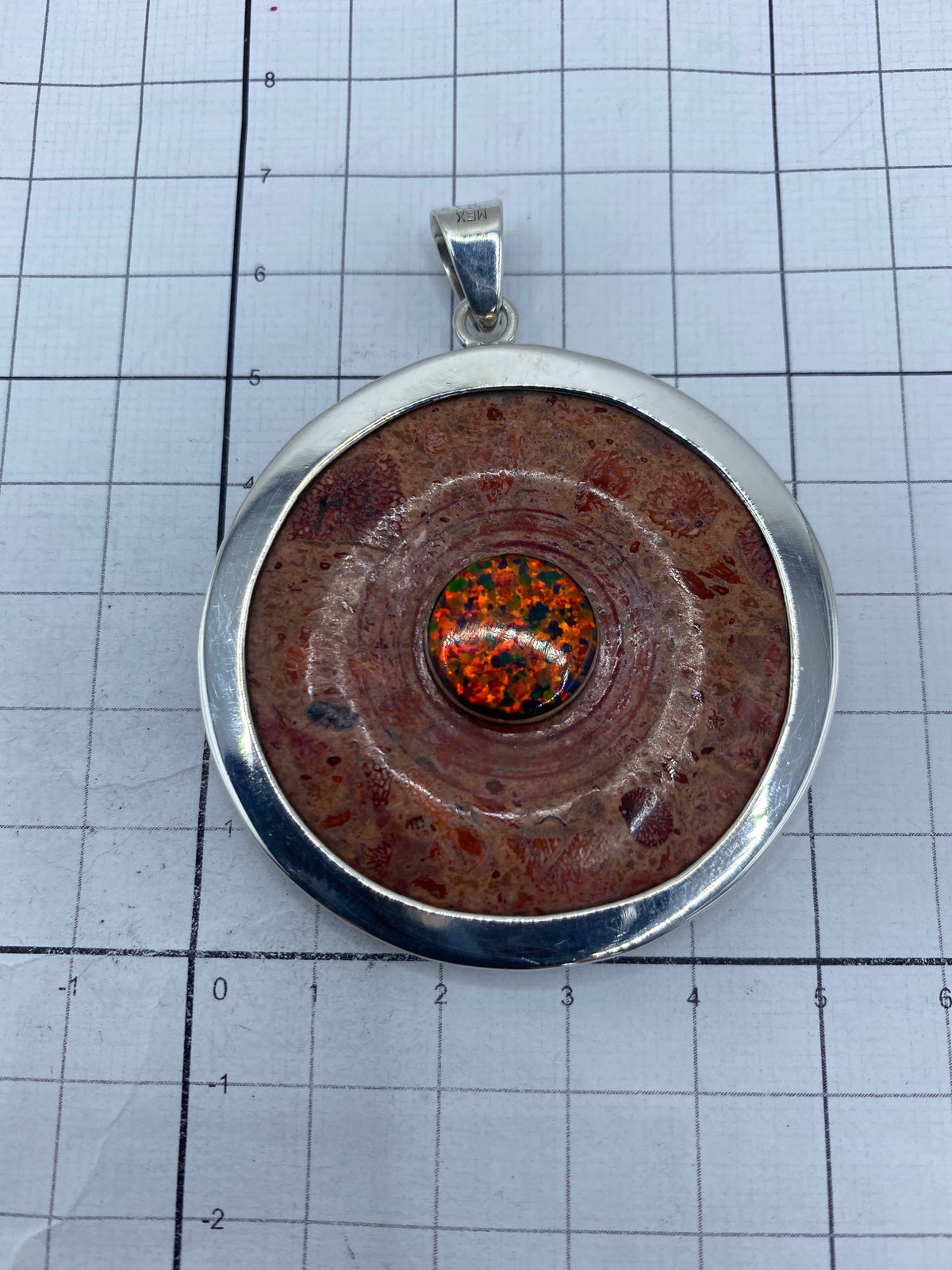 Dije sobre escala mostrando su tamaño real de 6.7 × 5.2 cm, comparativo con medidas