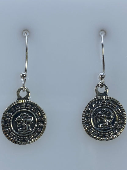 Aretes colgando en gancho de plata, vista lateral del motivo prehispánico