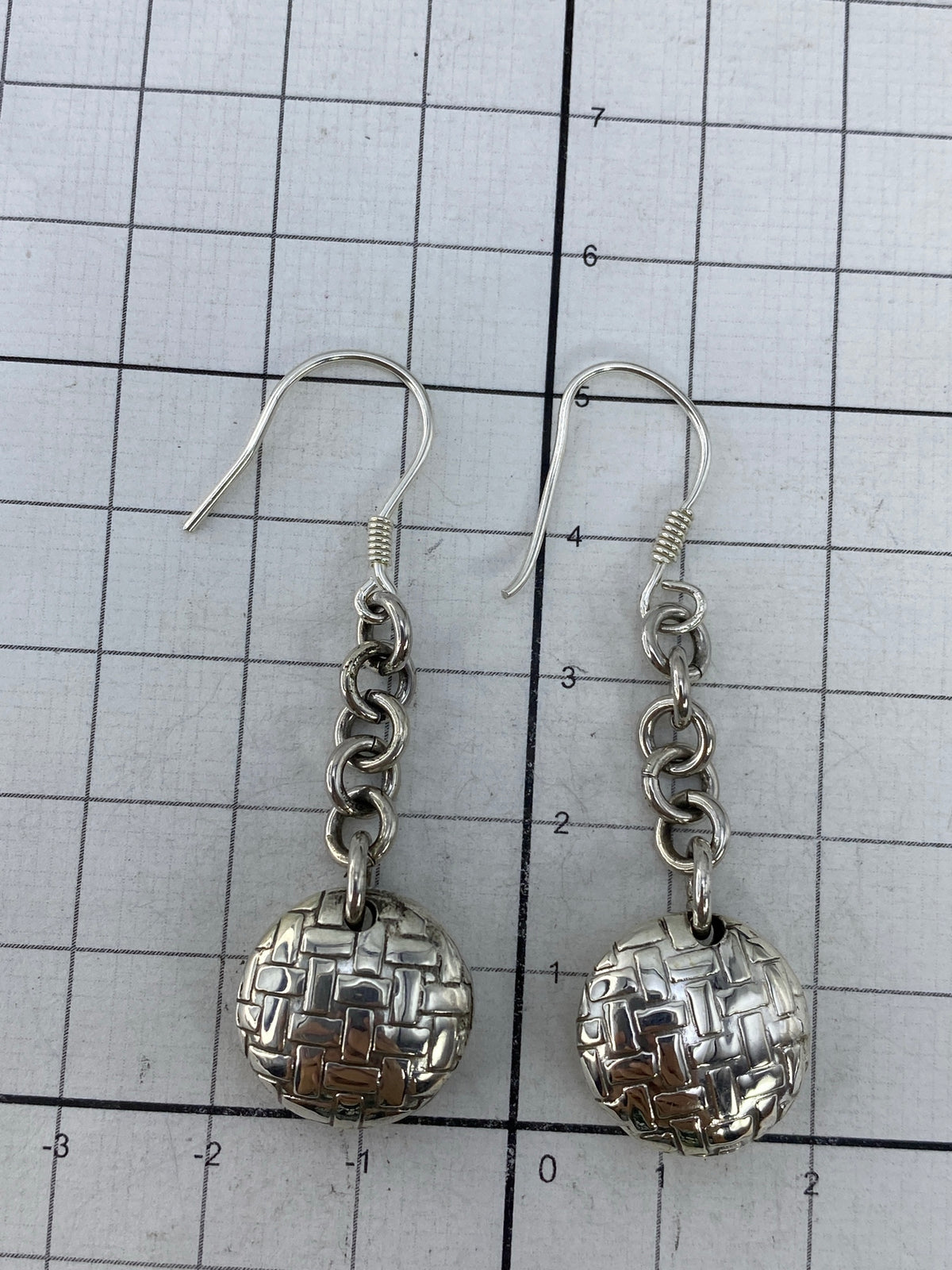 Aretes puestos de frente, mostrando la presencia geométrica y el largo de 5.1 cm