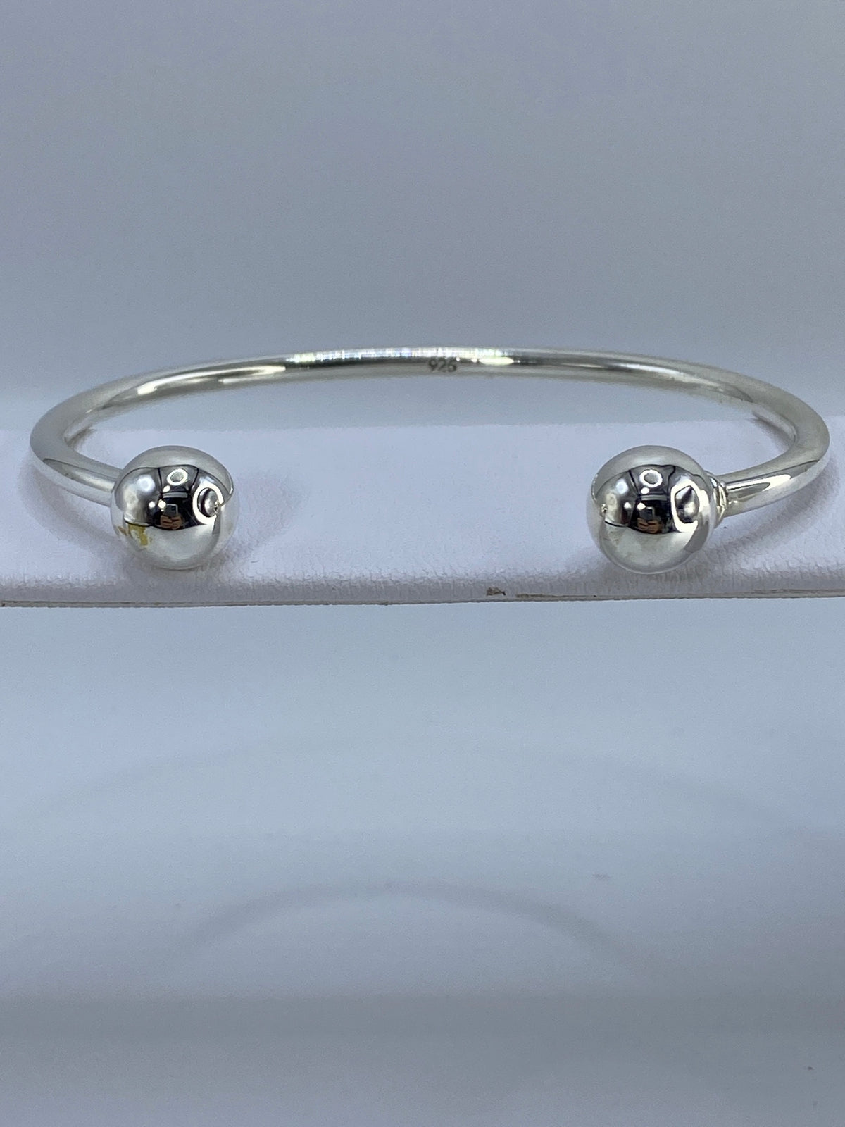 Brazalete de plata cartoneado en muñeca, vista frontal del diámetro interior de 6.7 cm