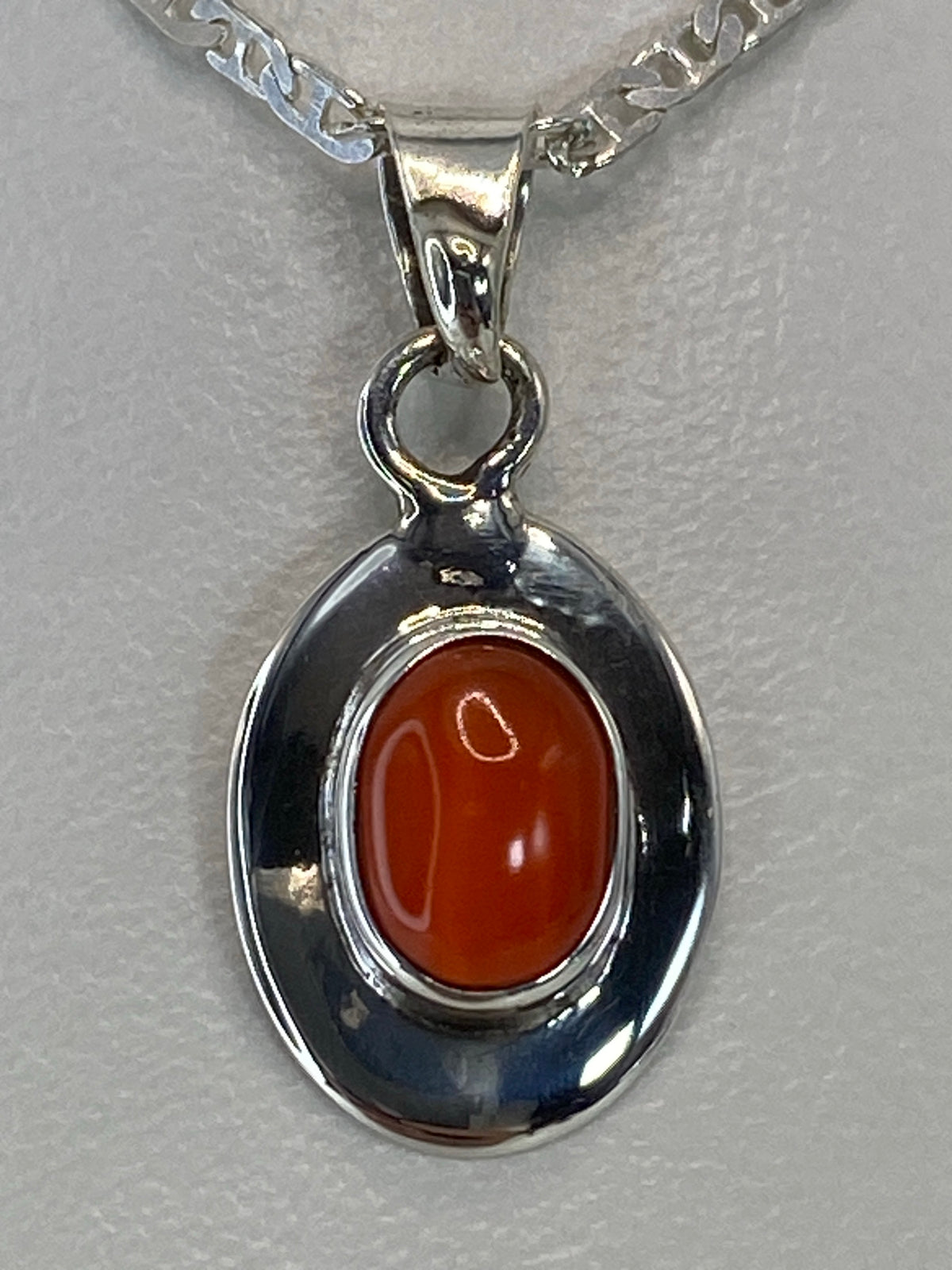 Detalle del engaste a mano de la piedra naranja en plata 925