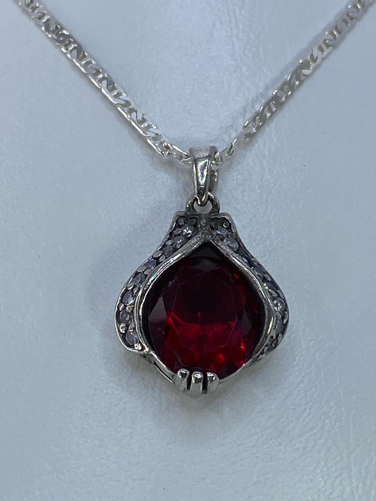 Detalle del engaste a mano de la circonia roja en plata 925