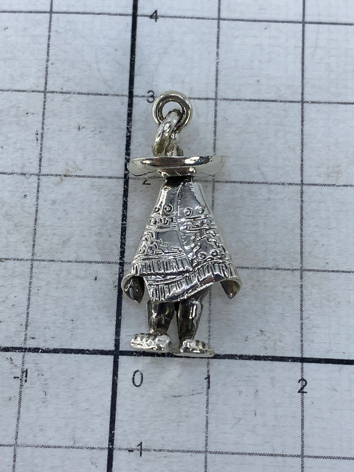 Dije de plata sobre escala mostrando peso de 2.9 gramos