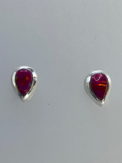 Aretes de plata con ópalo de fuego multicolor mostrando tonos rojo, naranja y amarillo