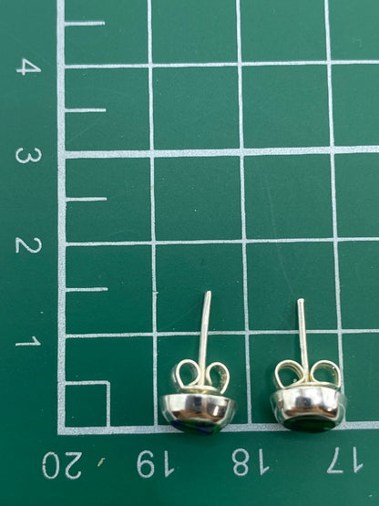 Aretes sobre regla de medición mostrando tamaño diminuto y peso de 0.85 g