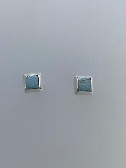 Aretes minimalistas de plata con piedra, ángulo lateral mostrando el grosor