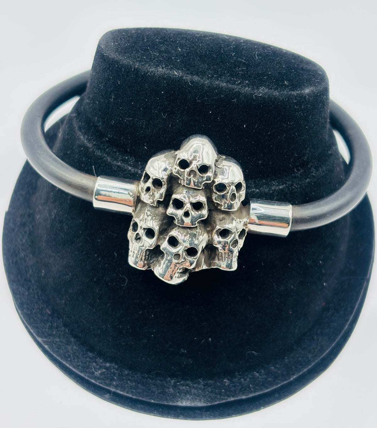 Pulsera de calaveras en plata .925 con caucho negro, cierre de gancho ajustable, 20cm de largo, hecha por Bravo Joyería en Taxco