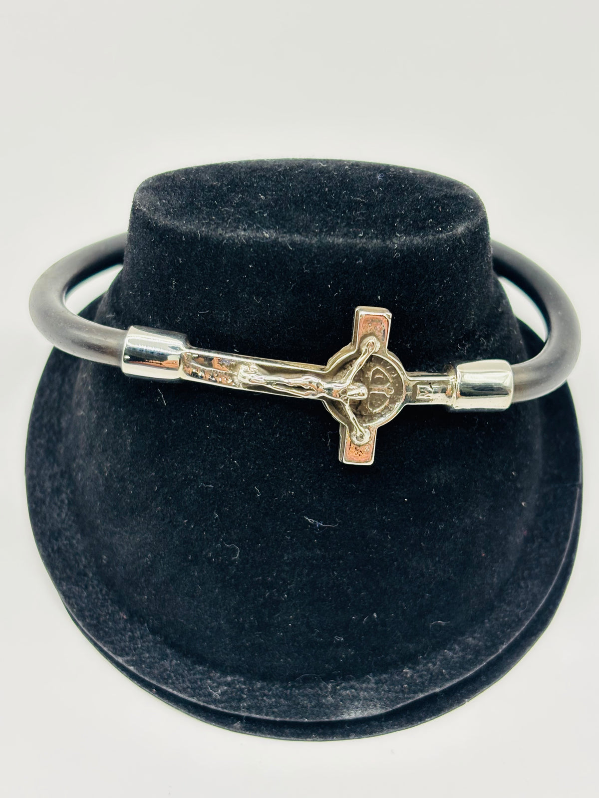 Pulsera de crucifijo en plata .925 con caucho negro de 20 cm, vista frontal sobre fondo gris